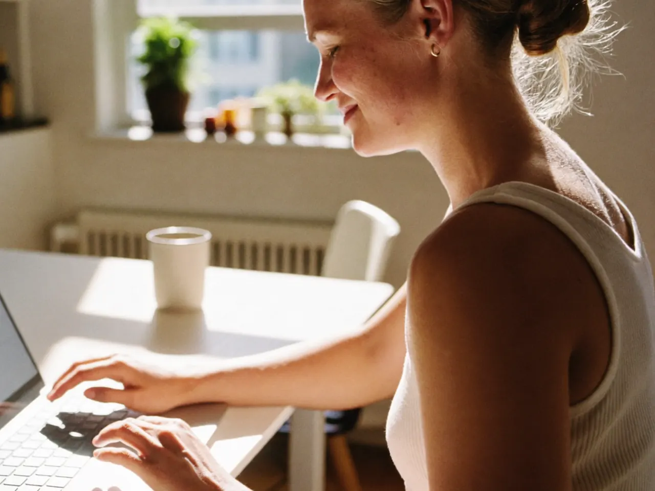 Homeowner comparing window quotes side by side on a tablet at a kitchen table