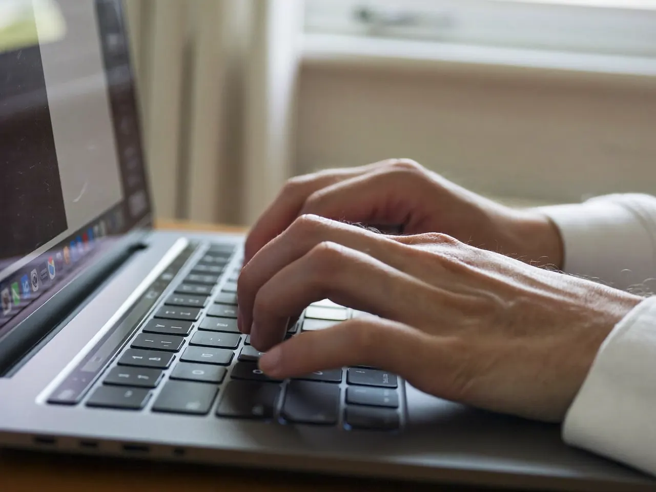 Person entering their contact details into an online window quote form on a laptop