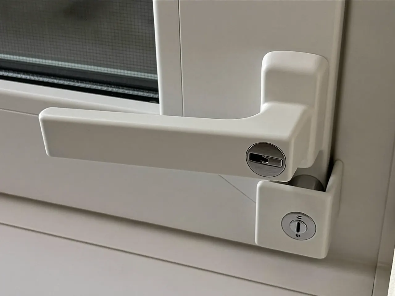 Close-up of a locking handle on a new double glazed window frame